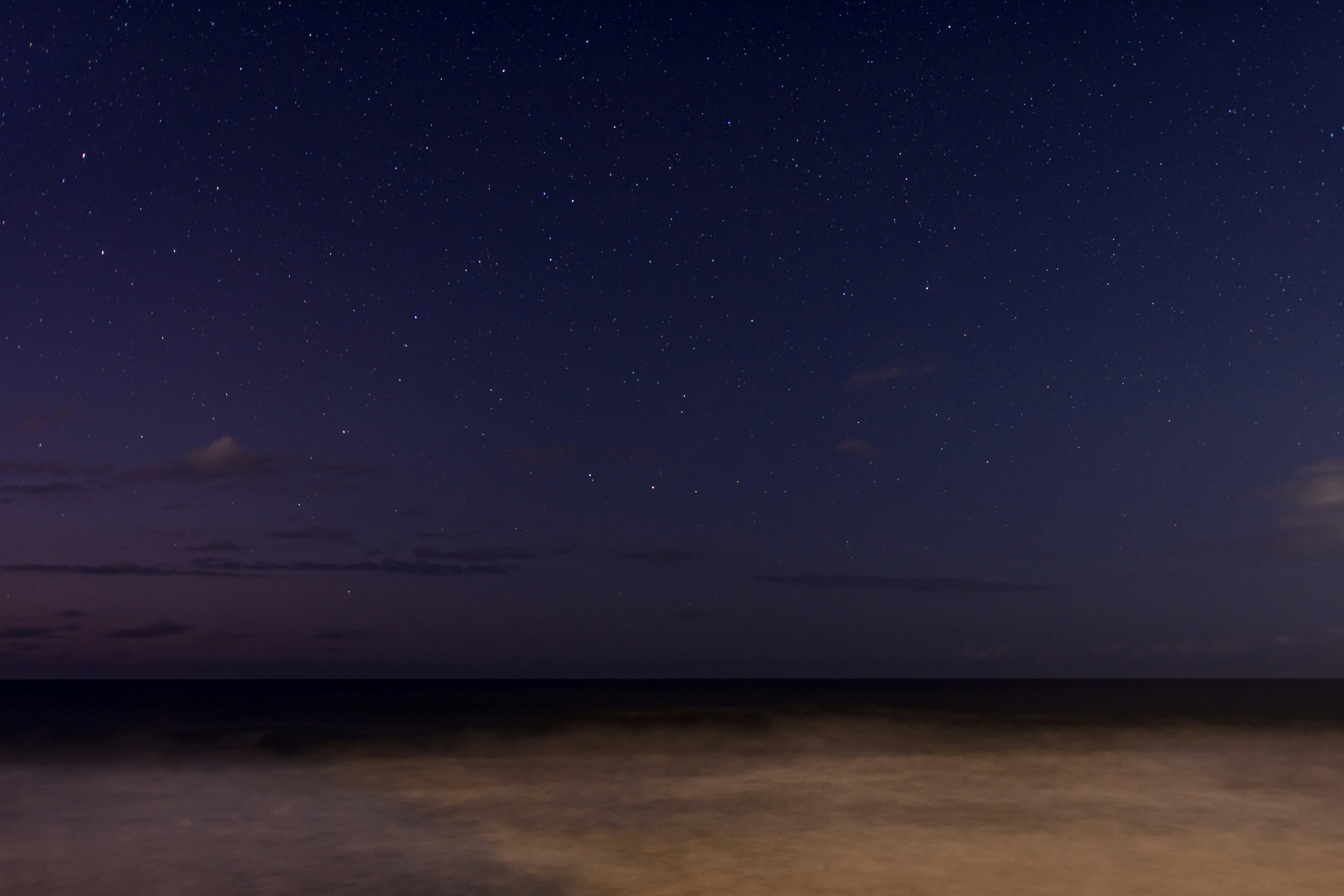 body of water under blue sky during night time